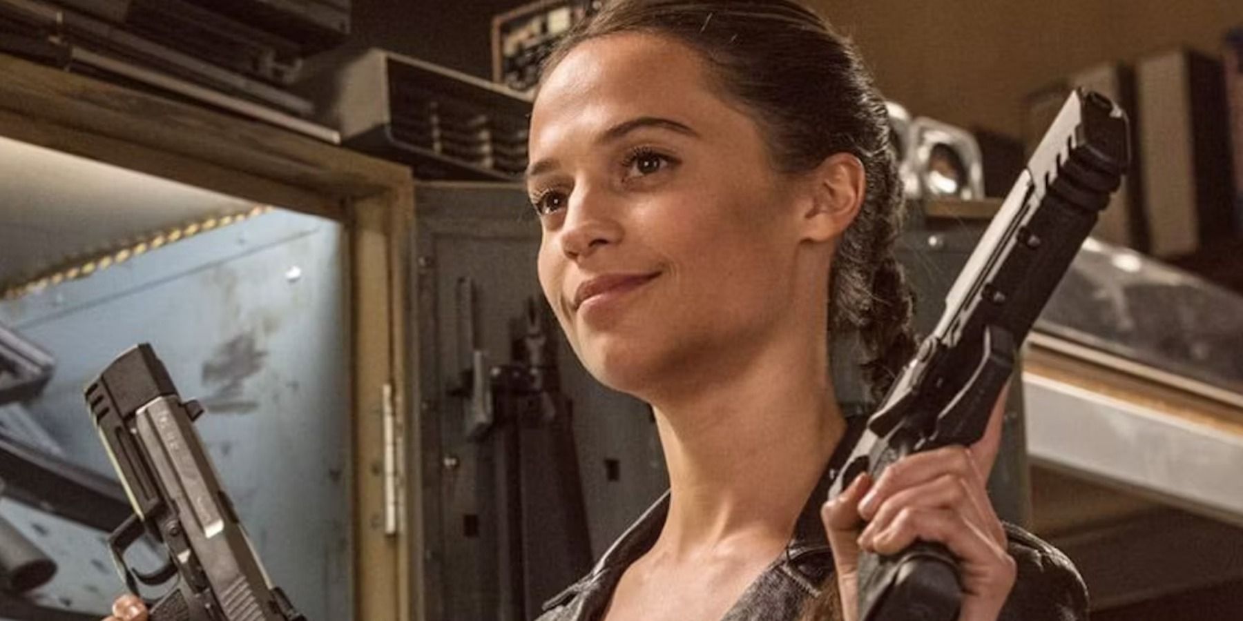 Alicia Vikander holding guns as Lara Croft Tomb Raider