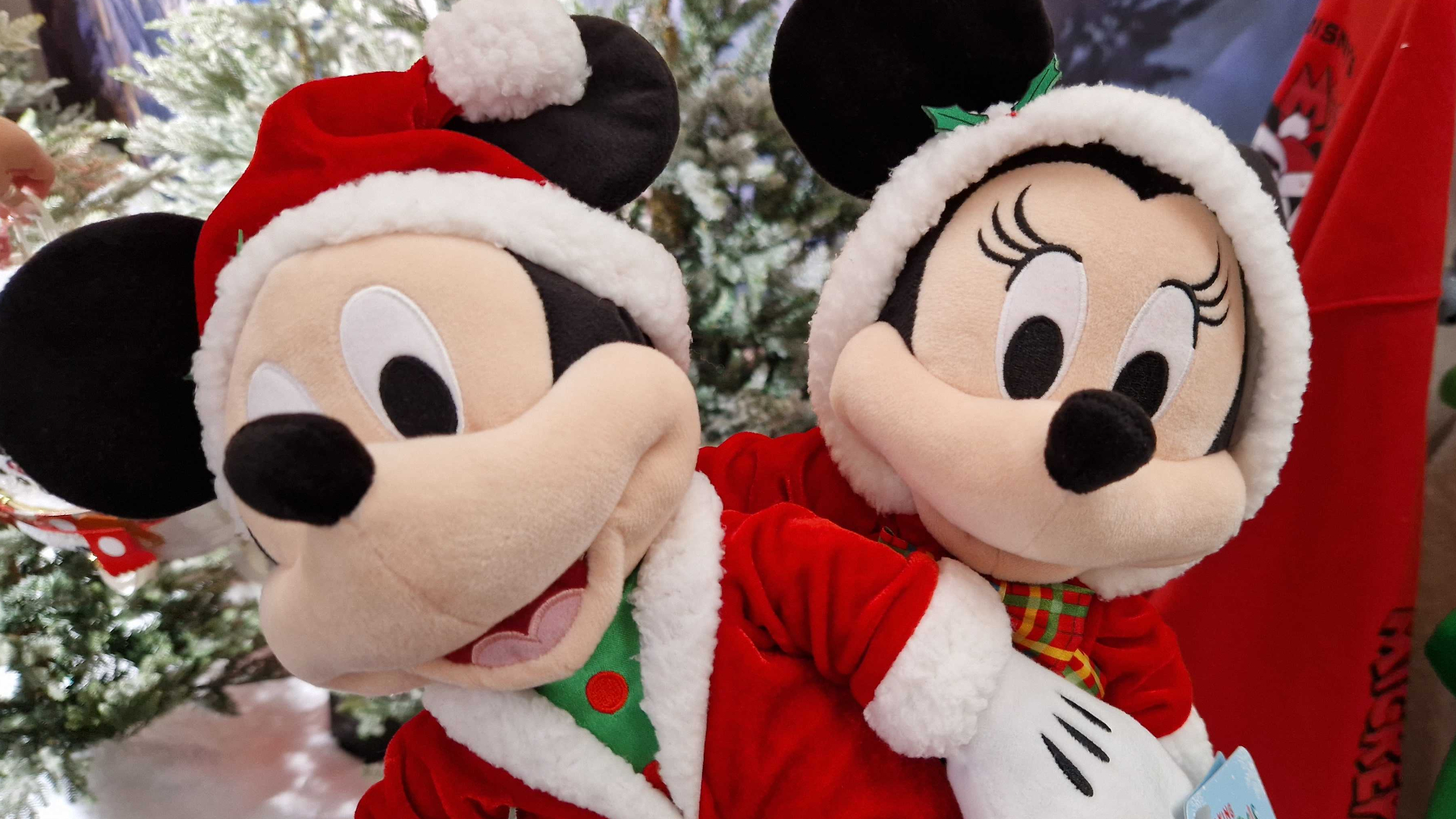 Mickey and Minnie Mouse Holiday plush toys against a snowy background