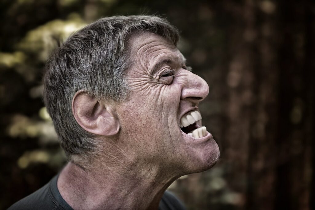 Guy with his mouth open to bite a mosquito