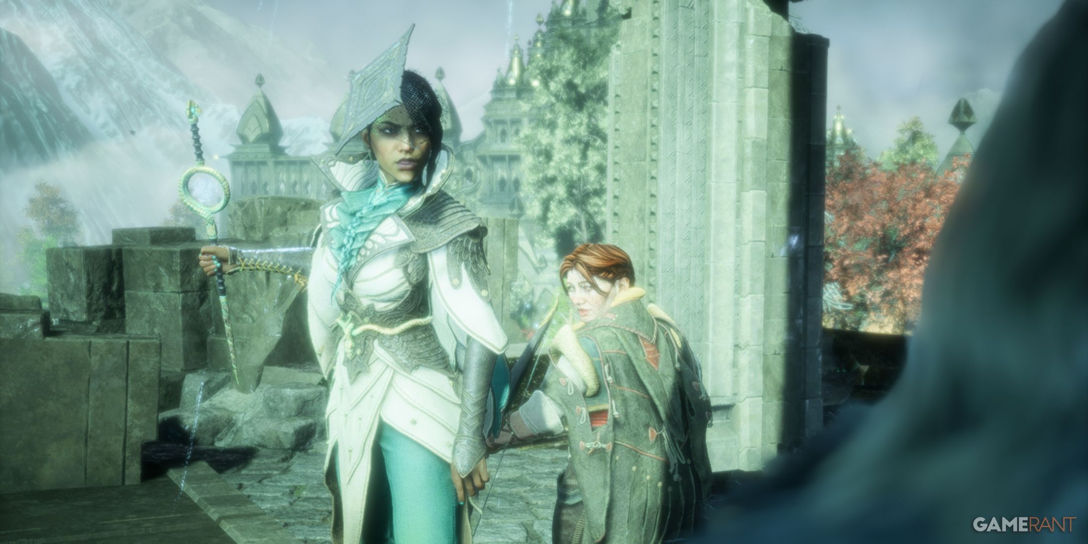 Neve and Harding stand ready, overlooking a scenic view of mountains and autumn foliage in Dragon Age