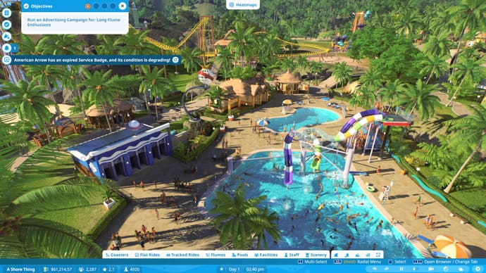 Planet Coaster 2 screenshot showing a Career mode park viewed from above, with the focus on several swimming pools and waterslides.