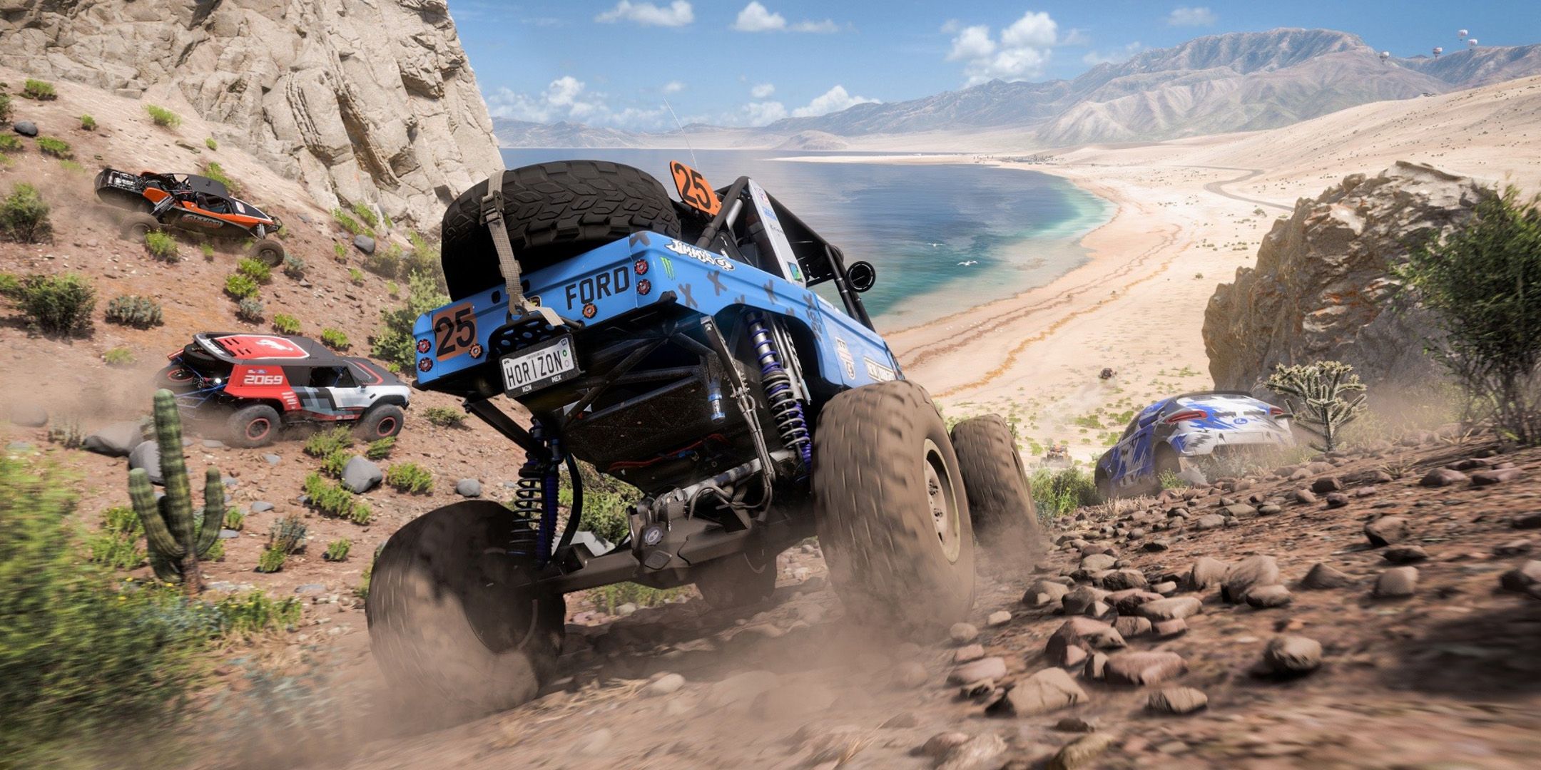 A blue Ford hi-riser racing other cars through a desert canyon in Forza Horizon 5.