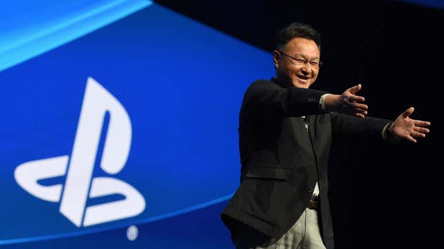 Shuhei Yoshida points to fans on stage for a PlayStation presentation in 2015.