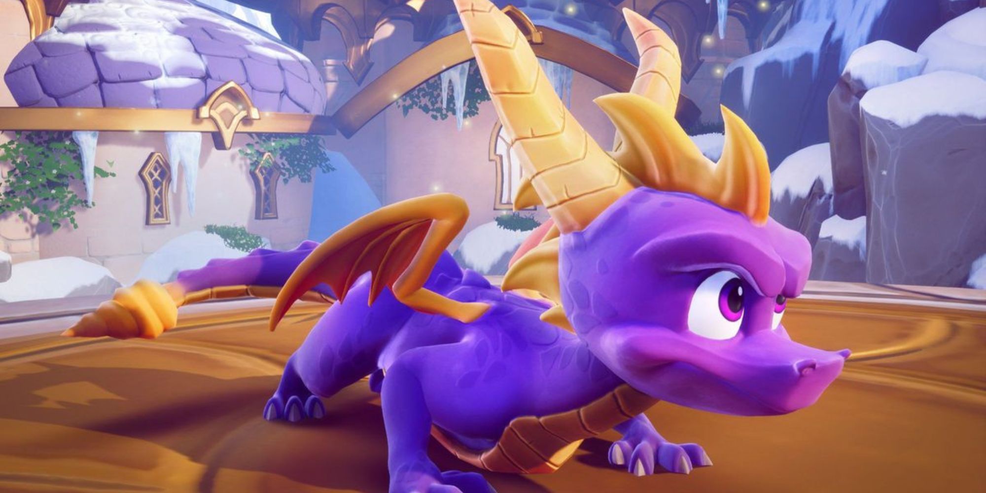 Spyro the Dragon crouches down by snowy mountains.