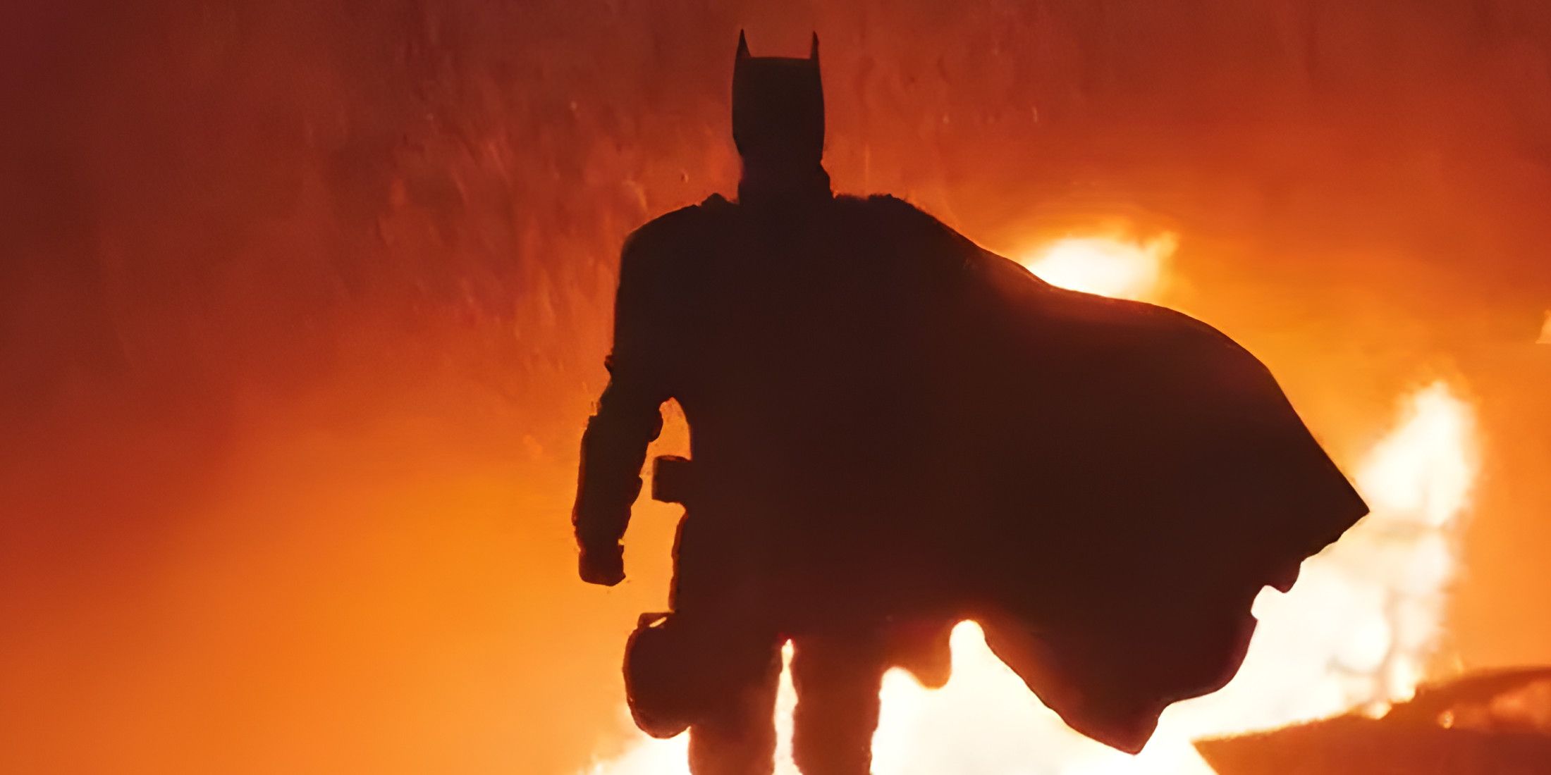 The Batman Walking Away from fire with silhouette