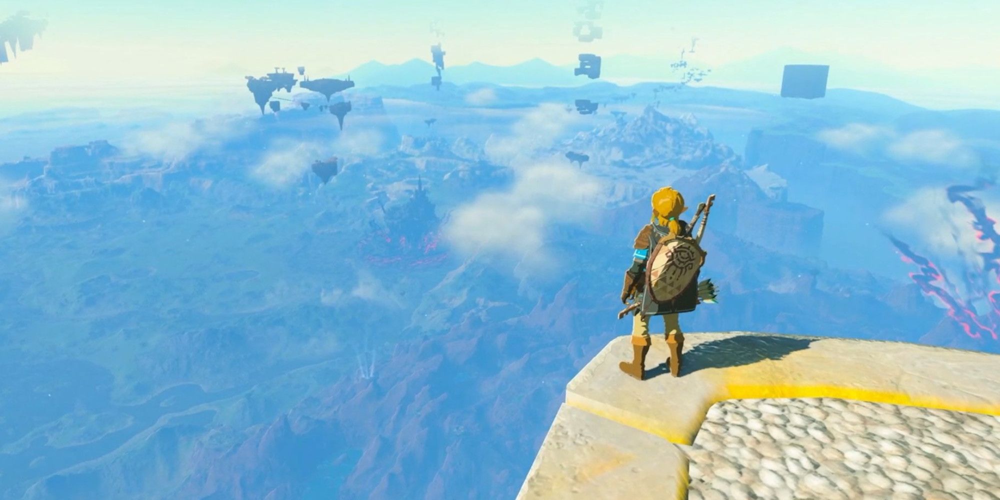 The Legend Of Zelda Tears of the Kingdom screenshot of Link on a ledge looking into the distance.