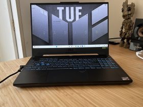 Asus TUF A15 gaming laptop open on a wooden desk