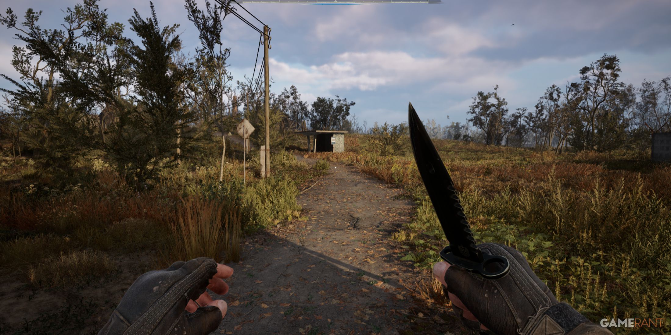 A player holding a knife while approaching a path surrounded by overgrown vegetation in STALKER 2