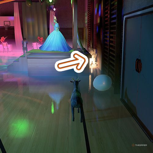 An orange arrow shows the location of a trophy that is behind the prom queen's platform in Goat Simulator Remastered