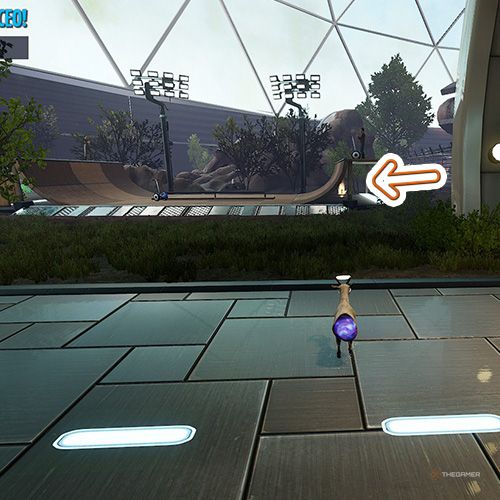 An orange arrow points the trophy that is behind a skate ramp in Goat Simulator Remastered