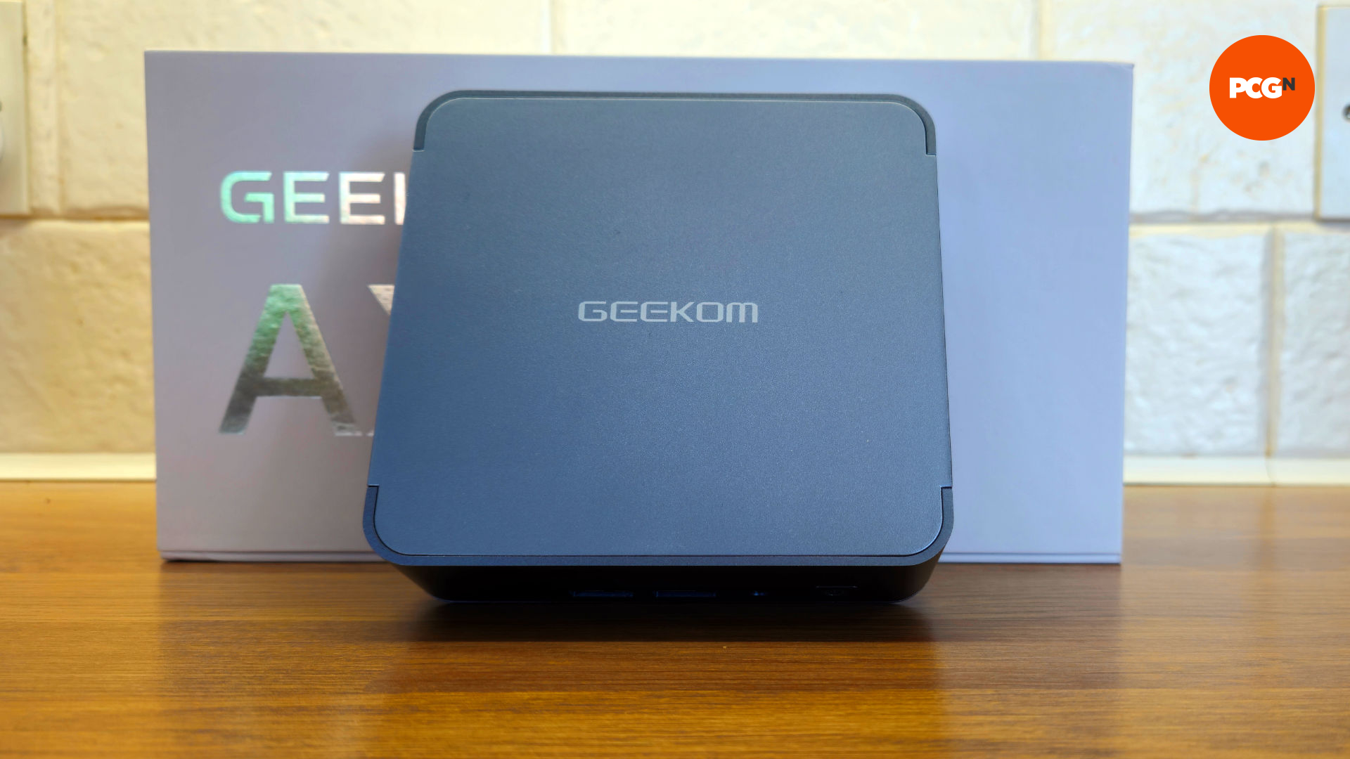 Front view of the Geekom AX8 Pro with box in view