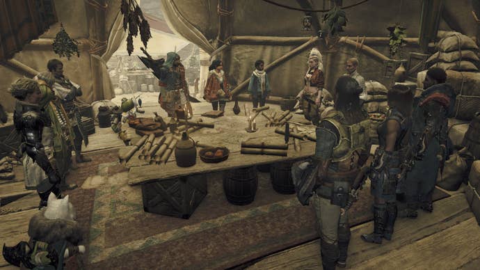 A group of hunters stand around a table in the middle of a tent, planning an expedition in Monster Hunter Wilds.