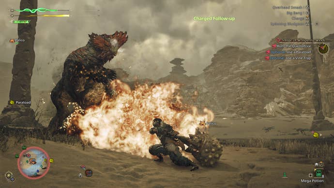 A hunter engages a Quematrice in Monster Hunter Wilds - there is an explosion as the best recoils away from the hammer-wielding player.