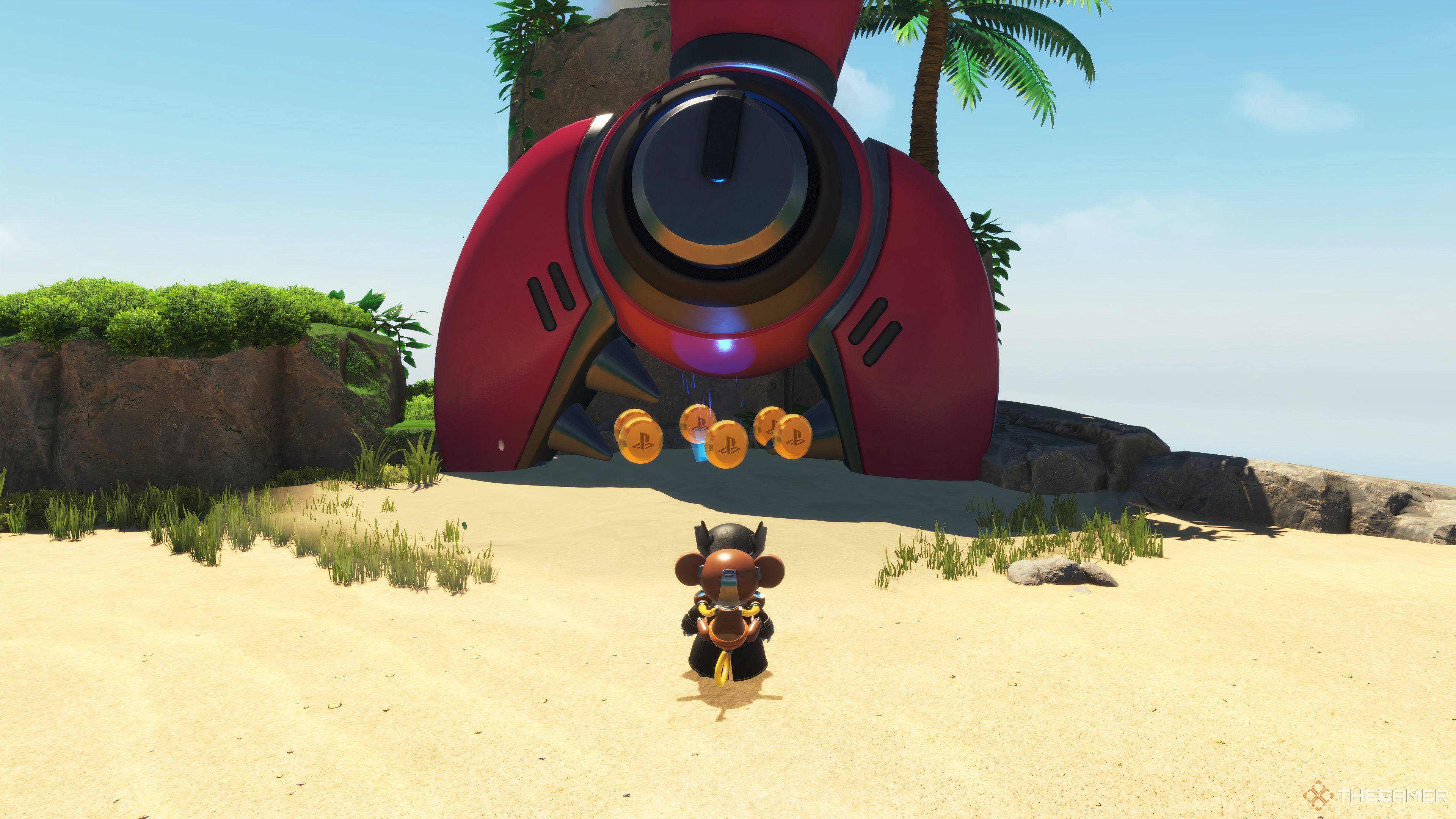 Astro standing in front of a large, mechanical claw buried in the sand.