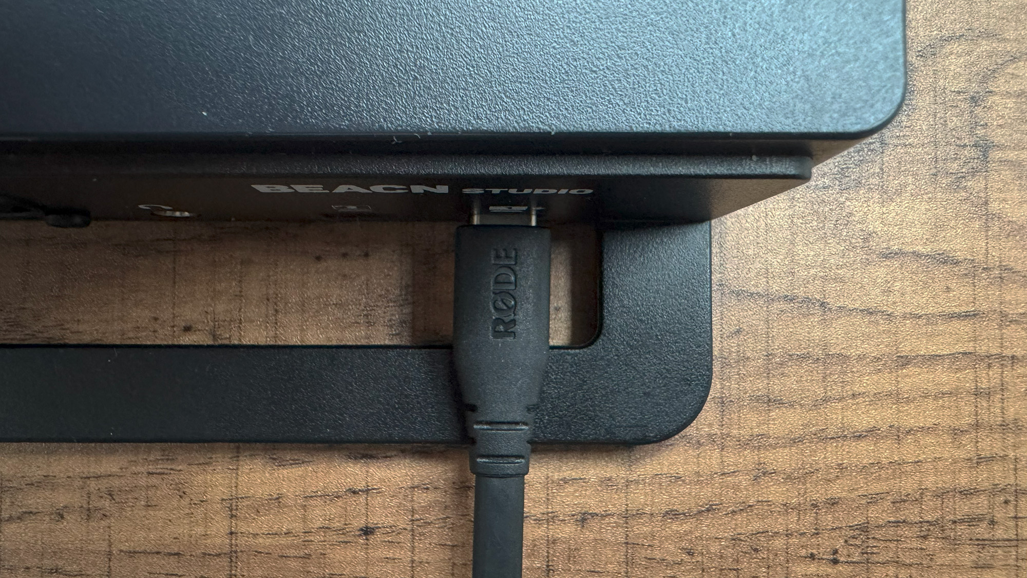 A BEACN Studio review image of a USB-C cable poking out of its back from above