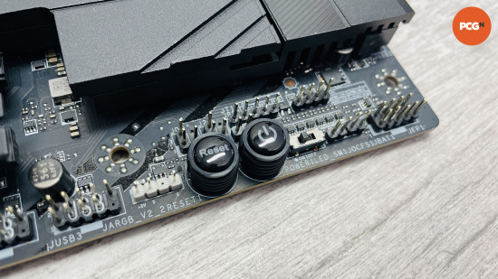 MSI MPG X870E Carbon WiFi review: Power and reset buttons on motherboard.