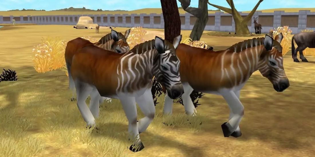 Animals walk through an enclosure in Zoo Tycoon 2.