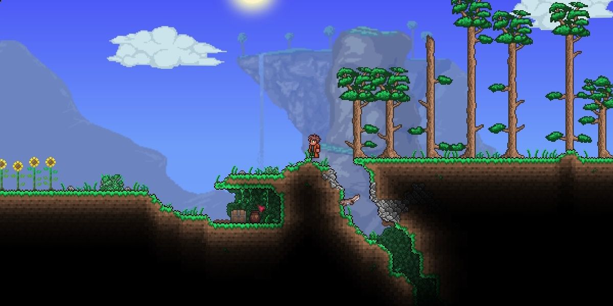 Terraria player standing next to a hole and some trees during the day.