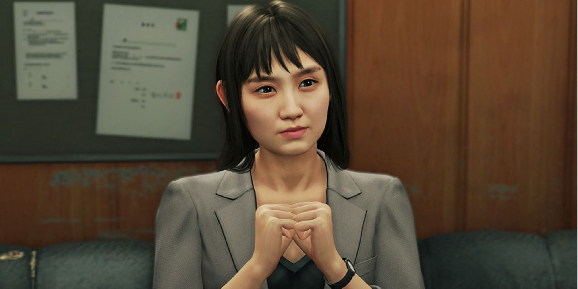 Eri sitting with her hands folded in Yakuza: Like A Dragon.