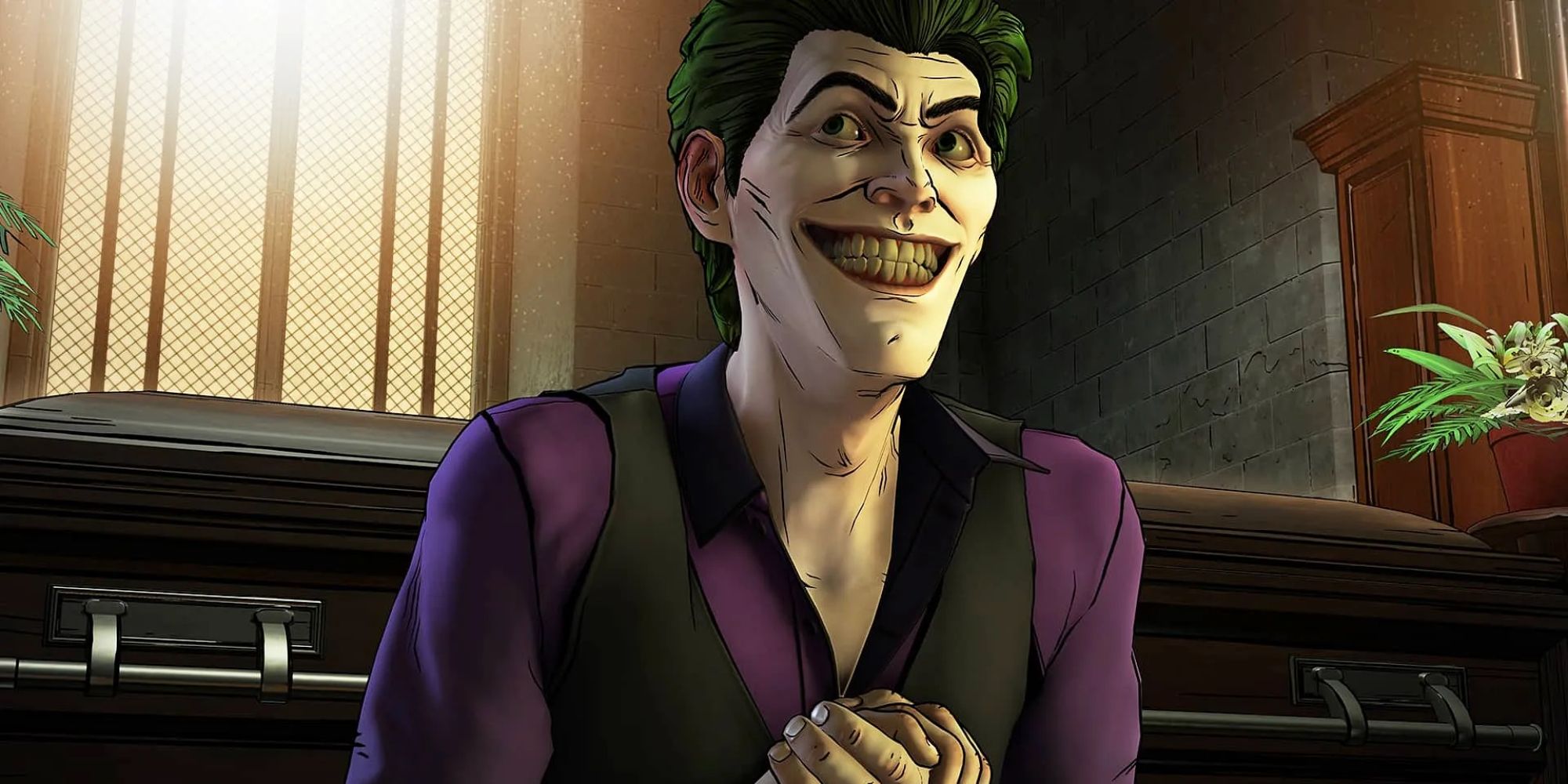 Batman Enemy Within screenshot of Joker infront of a casket with a smile on his face.