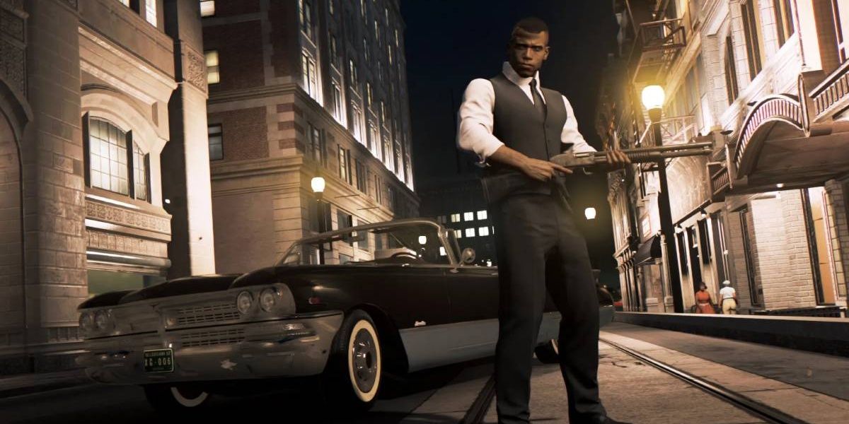 Lincoln Clay with a gun standing in front of a car in Mafia III.