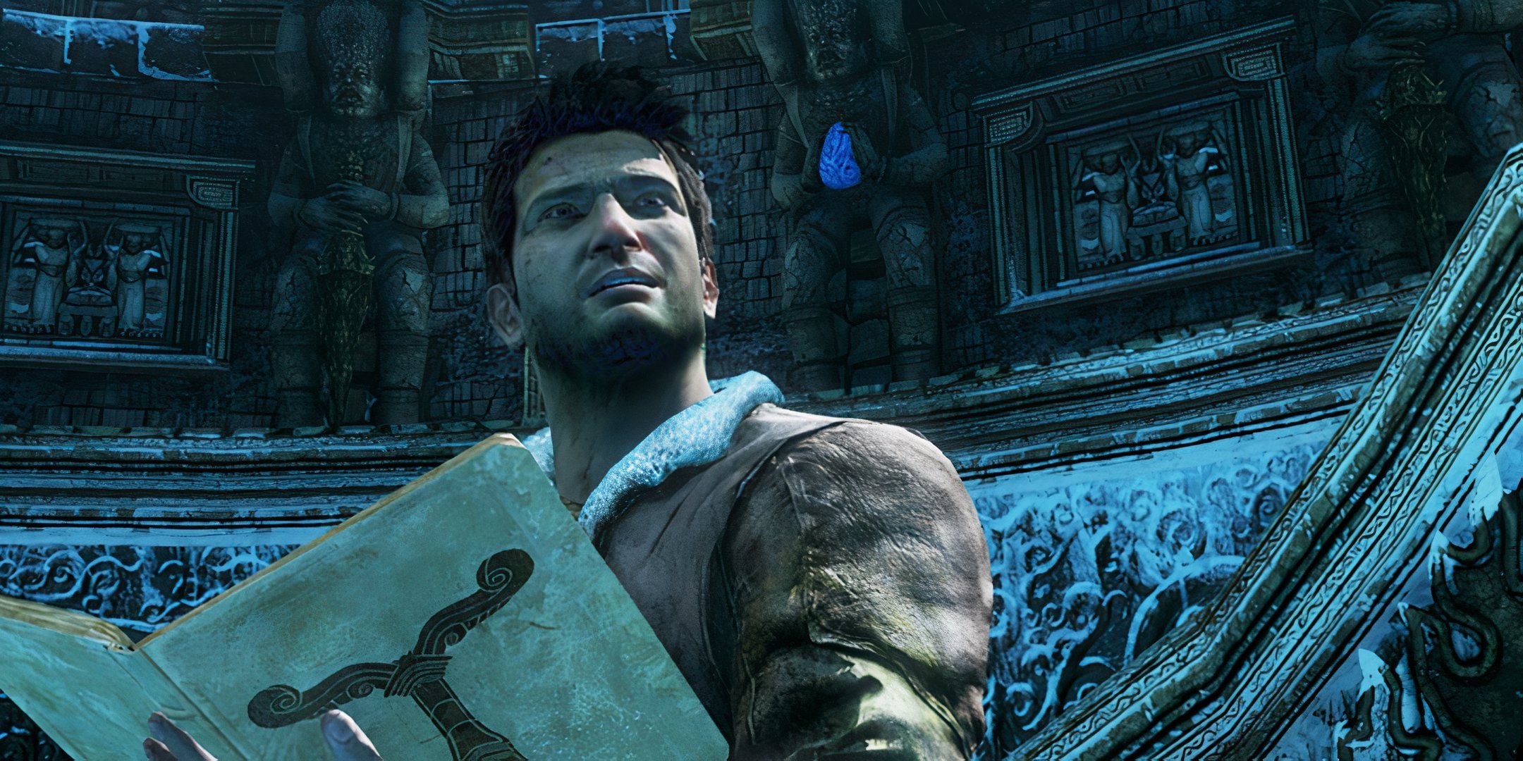 Nathan Drake holding a map in an icy cave in Uncharted 2.