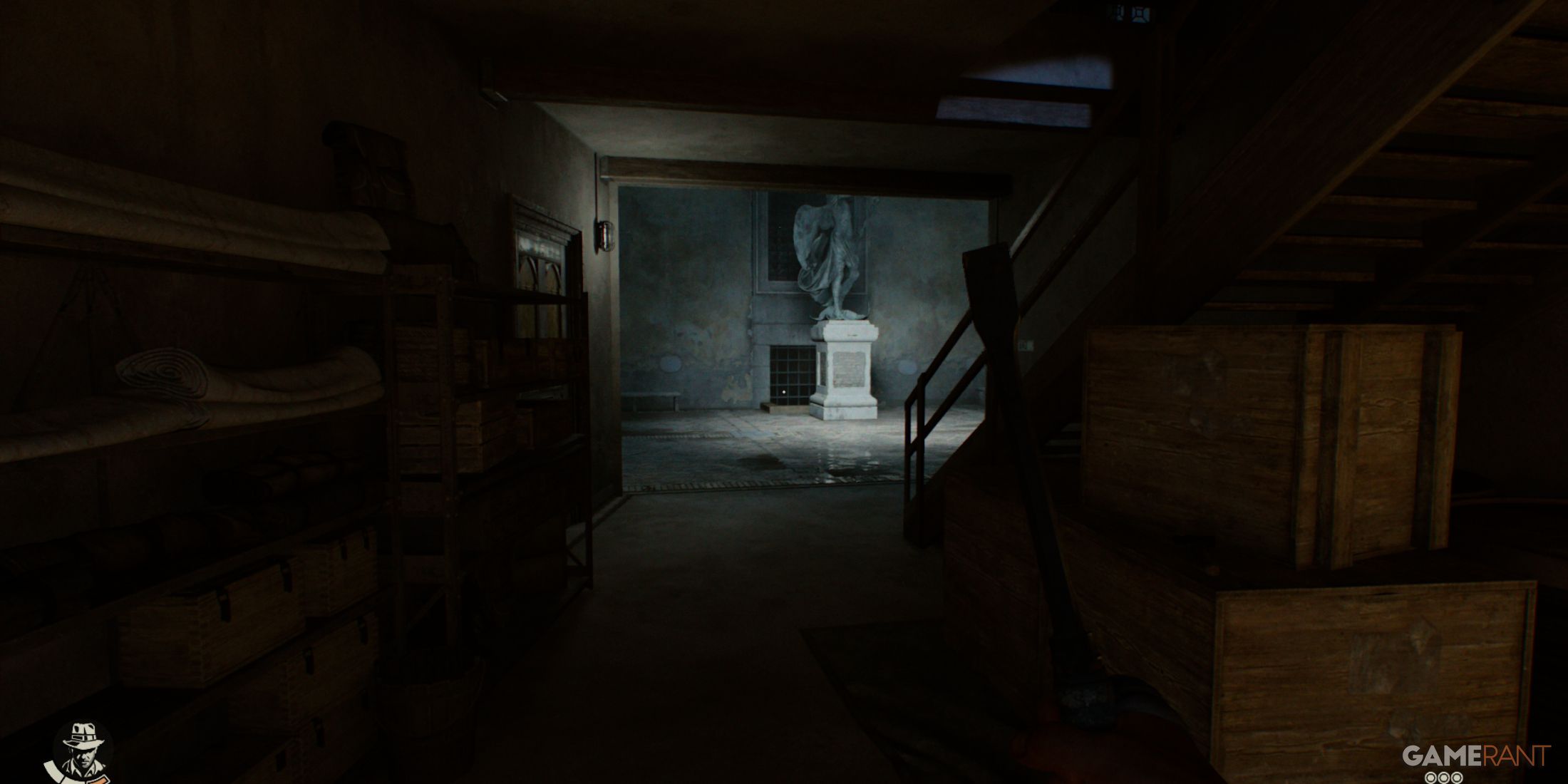 A dark basement area with stairs and a statue visible through an open doorway in Indiana Jones and The Great Circle