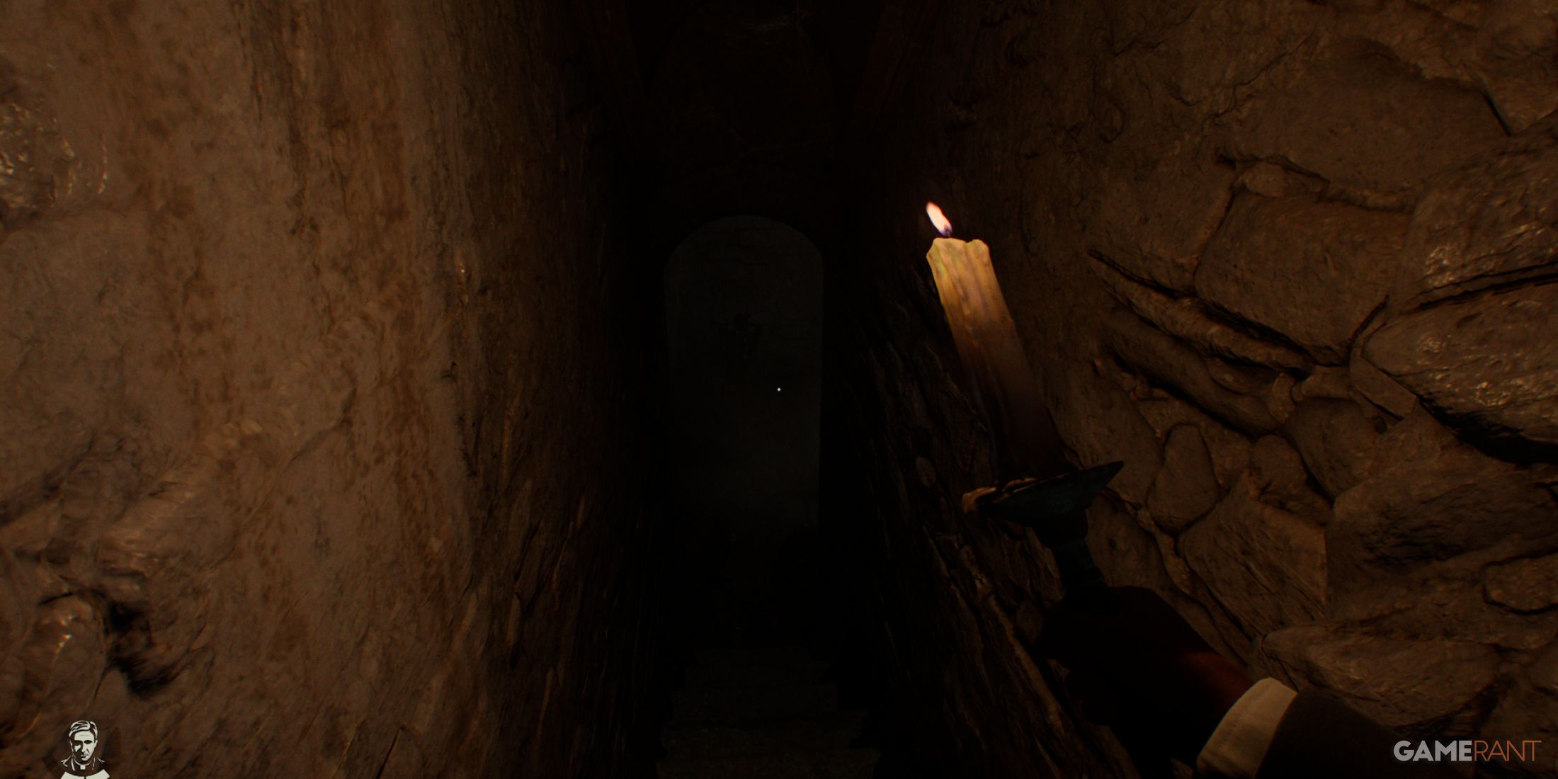 A narrow, dimly lit stone staircase illuminated by a handheld candle in Indiana Jones and The Great Circle