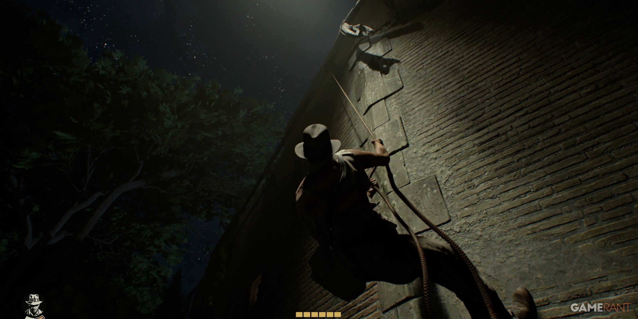 Indiana Jones climbing a brick wall under a starry night with stamina indicators on screen in The Great Circle