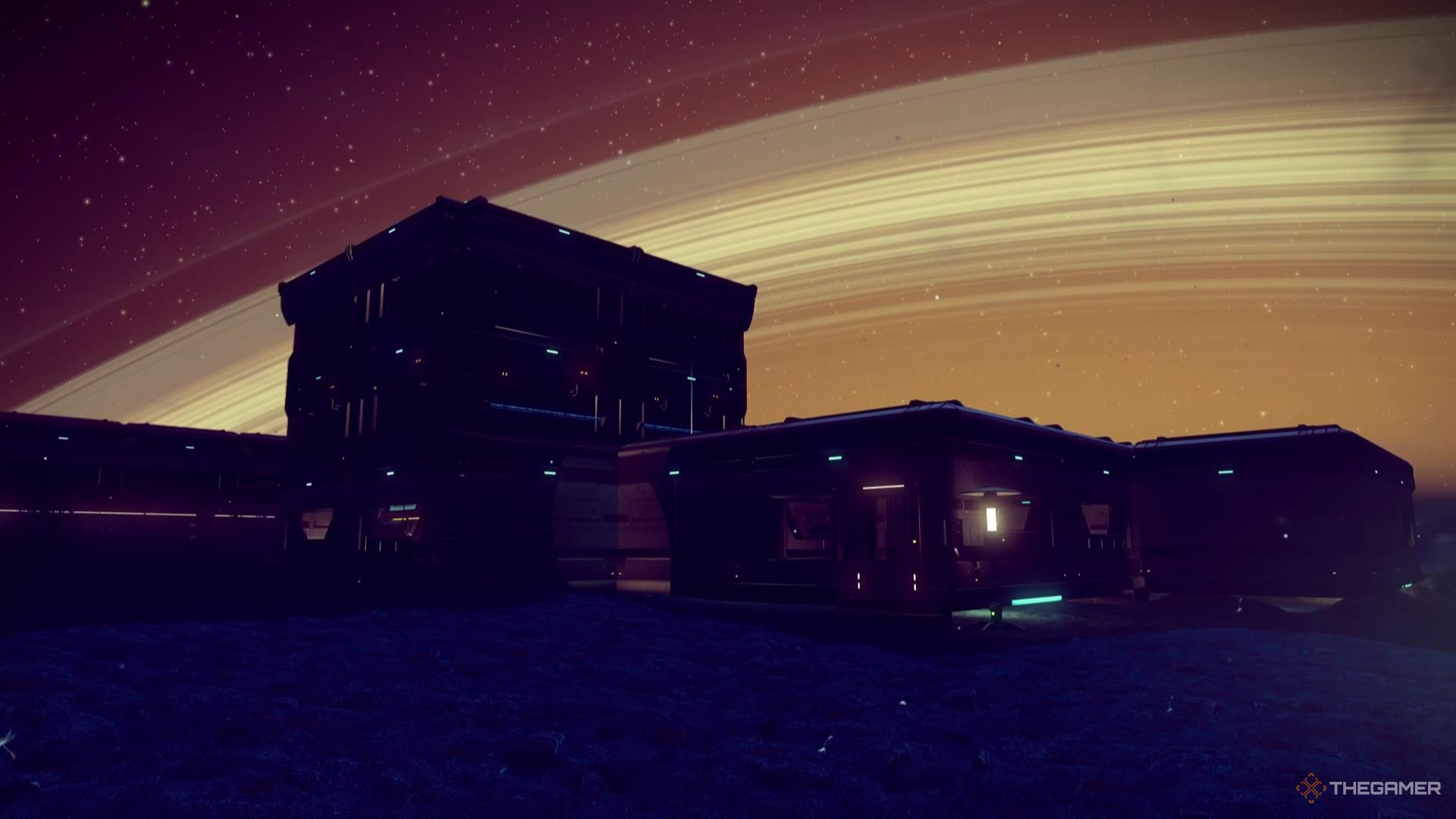 A small base sits in front of the ring of a planet taking up much of the night sky in No Man's Sky.