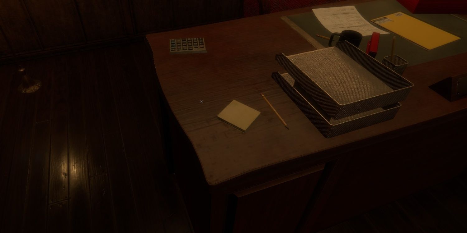 Paper and pencil on a desk with other office supplies in The Mortuary Assistant.