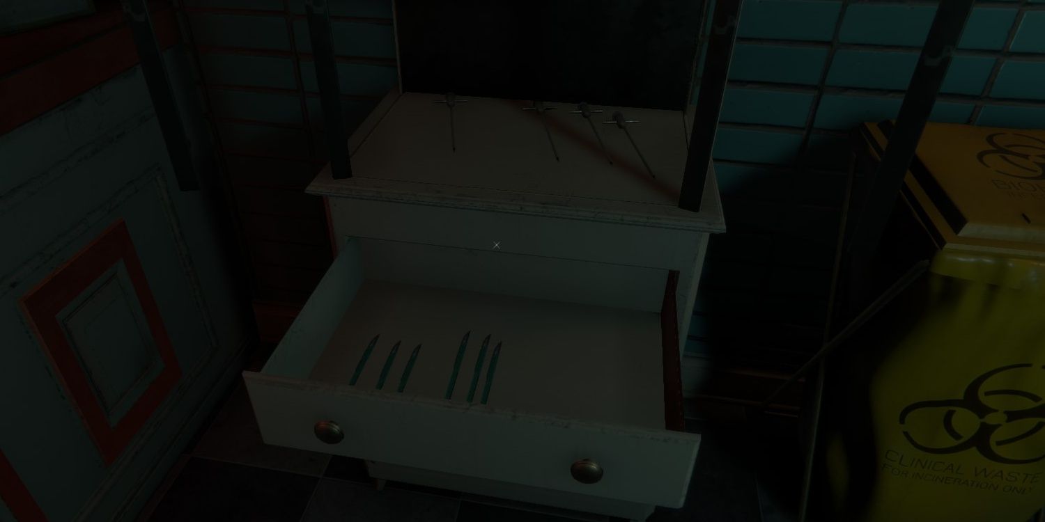 An open drawer with an array of scalpels inside.