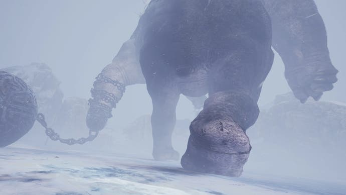 A skycraper-sized behemoth strides away from the player, dragging a gigantic iron ball on a chain behind it.