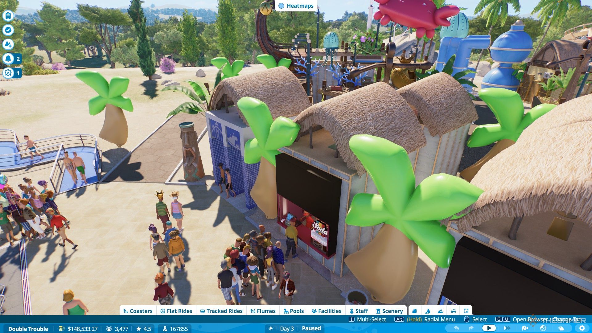 The player decorates the park's facilities with balloon palm trees in Planet Coaster 2.