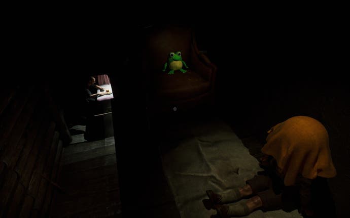 Screenshot of a frog sat on a chair in The Cabin Factory. Also visible is a model of a boy with a sheet over his head and a model of a dad.