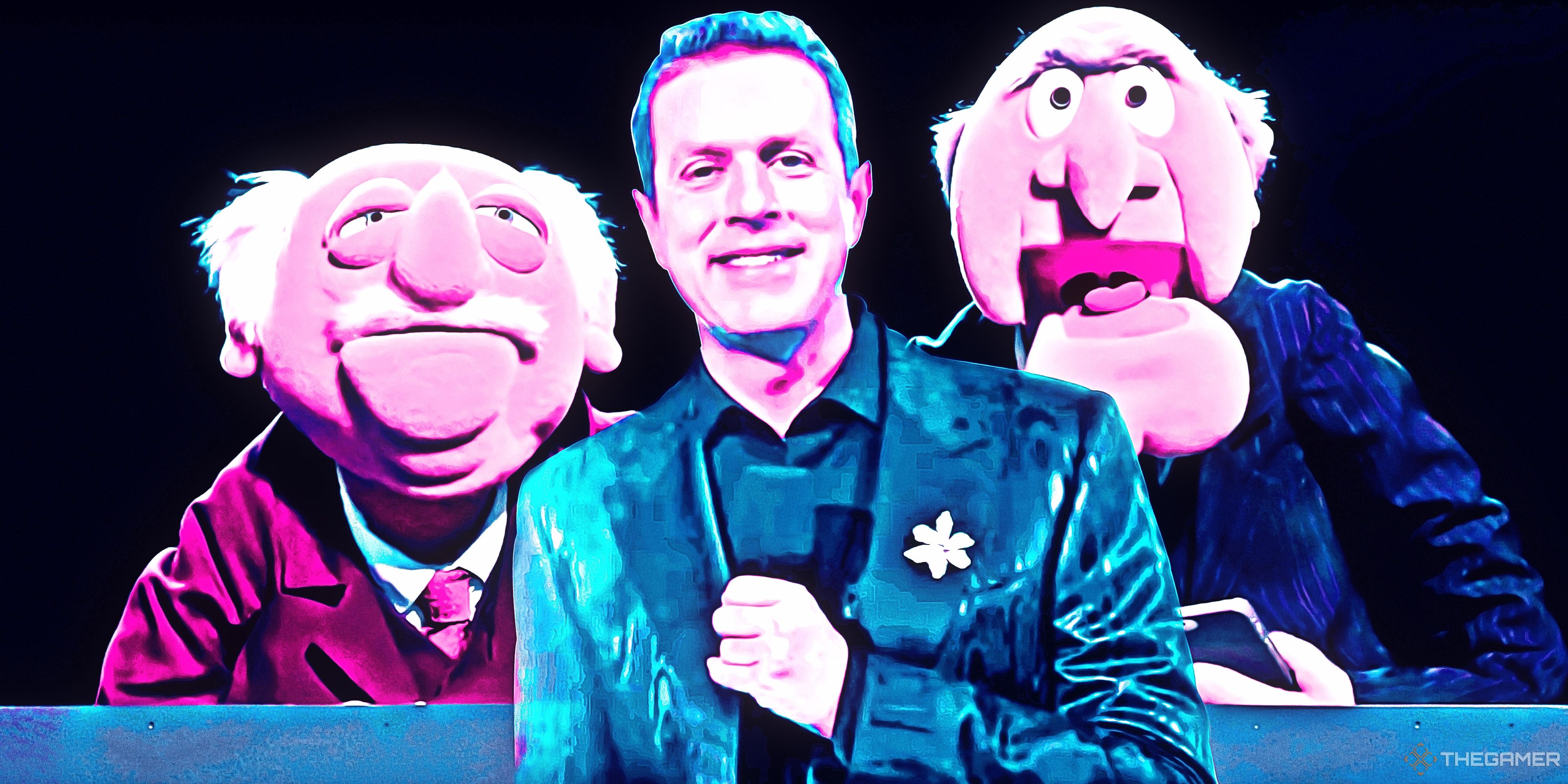 Geoff Keighley holding a mic and smiling in front of the Muppets Statler and Waldorf.