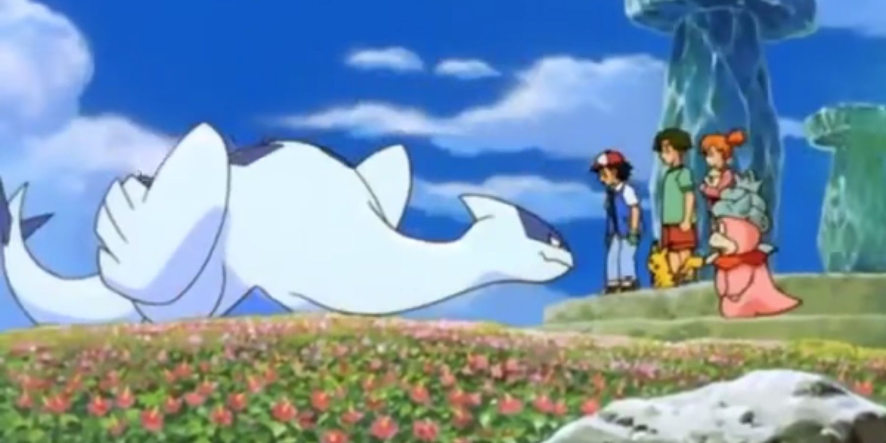 Lugia bows to Ash and his friends.