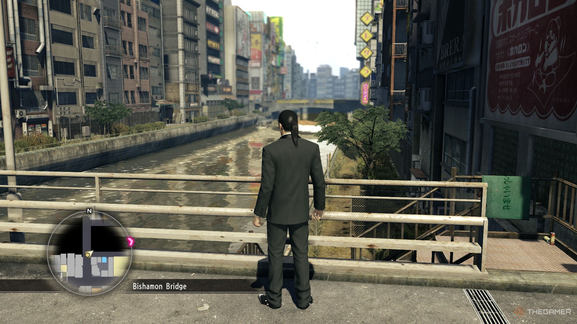 Majima is looking at Sotenbori River across the bridge in Yakuza 0.