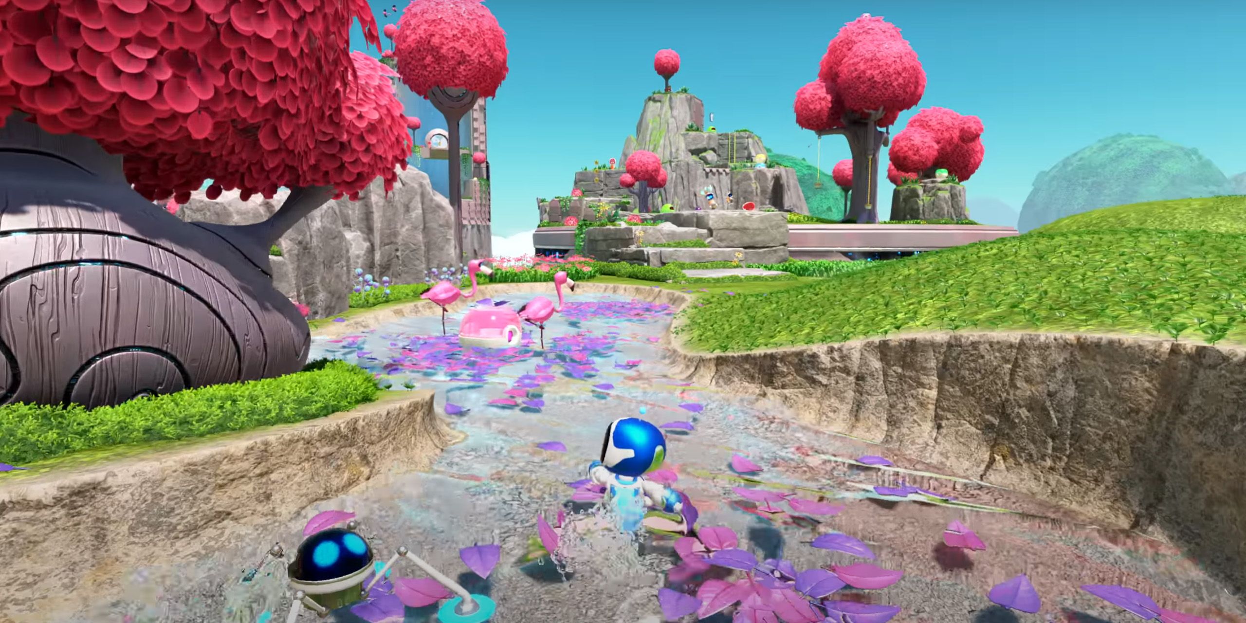 Astro Bot running through a pond filled with petals and flamingos.