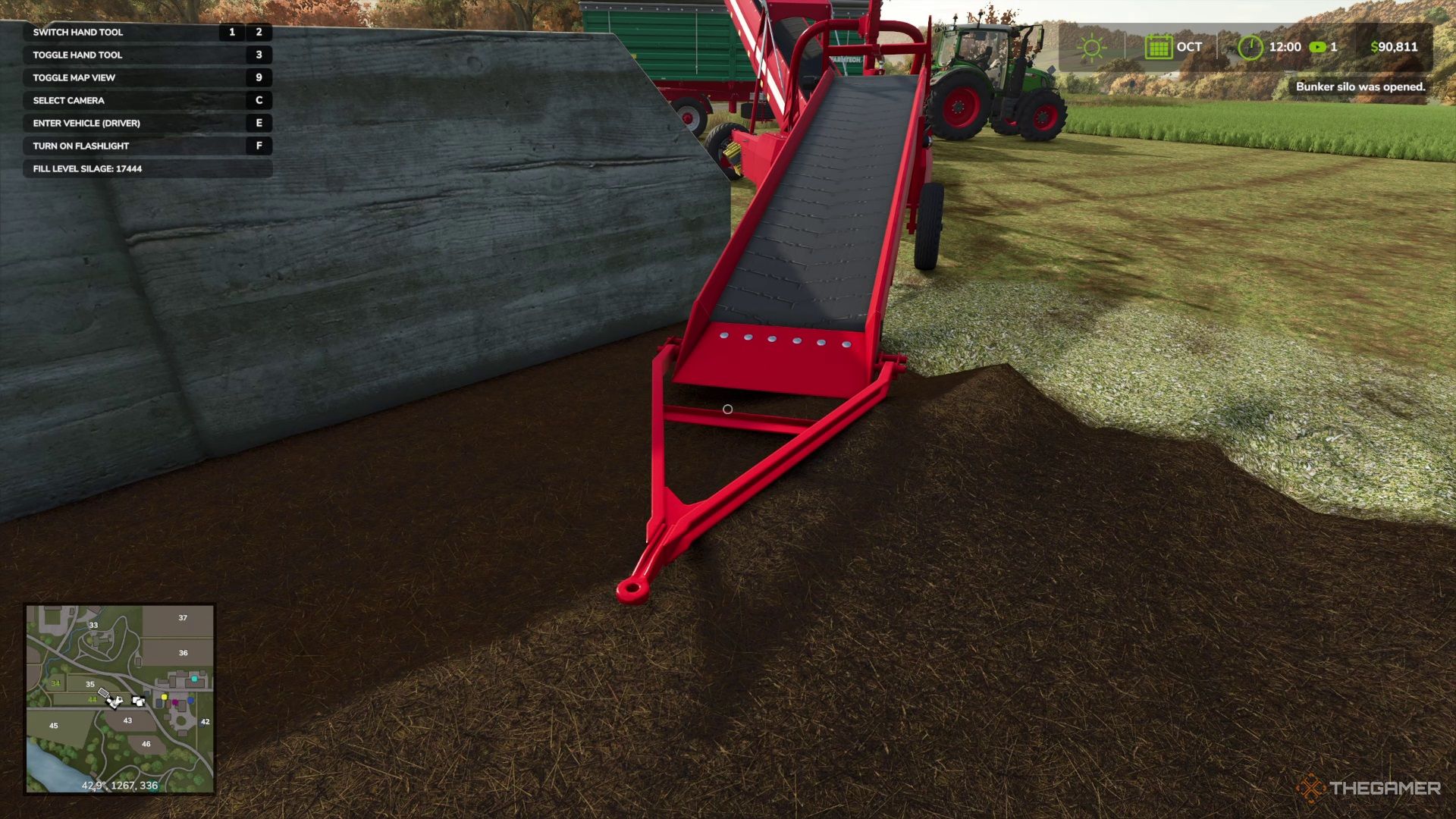 A conveyor belt system leading from a silage bunker into a trailer in Farming Simulator 25.