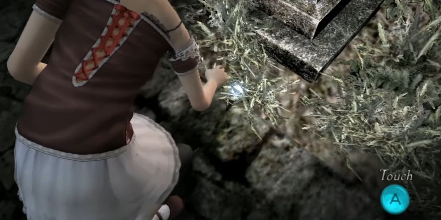 Going down to grab an item in Fatal Frame 2: Wii Edition.