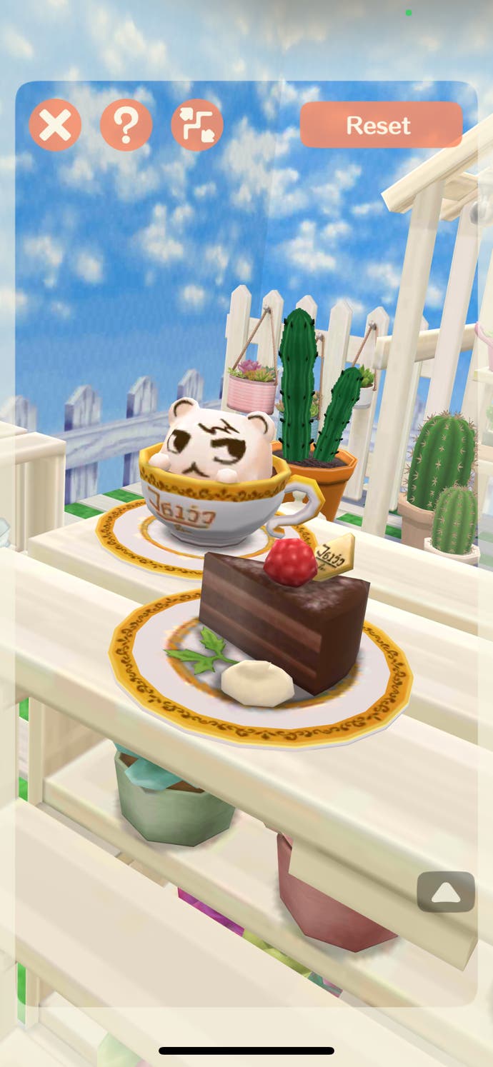 Animal Crossing: Pocket Camp Complete screenshot with the AR camera view of a chocolate cake and latte art featuring Marshal the squirrel's face.