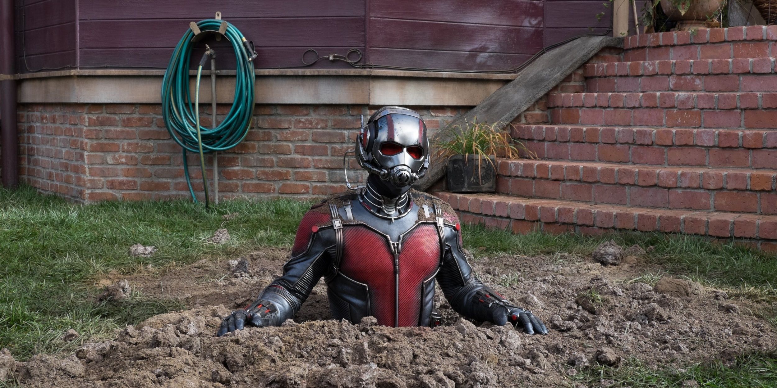 Ant-Man stuck in a hole trying to learn his suit's abilities.