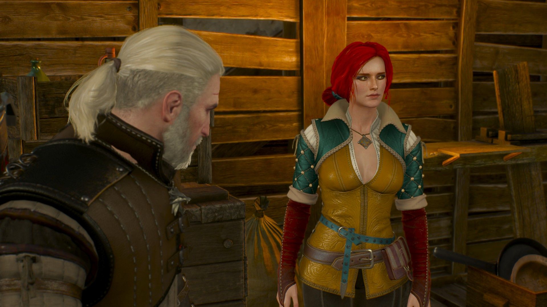 Geralt and Triss talk inside a disused shack in Novigrad.