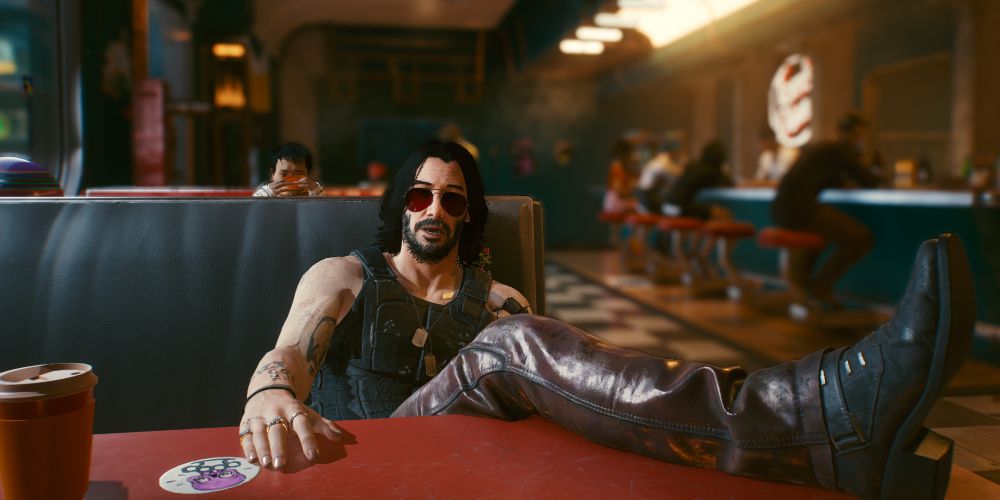 Cyberpunk 2077 screenshot of Johnny Silverhand with his feet up at the diner.