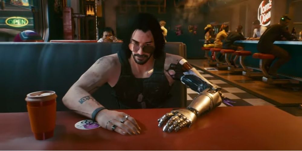 Cyberpunk 2077 screenshot of Johnny Silverhand witting at a booth in a diner.