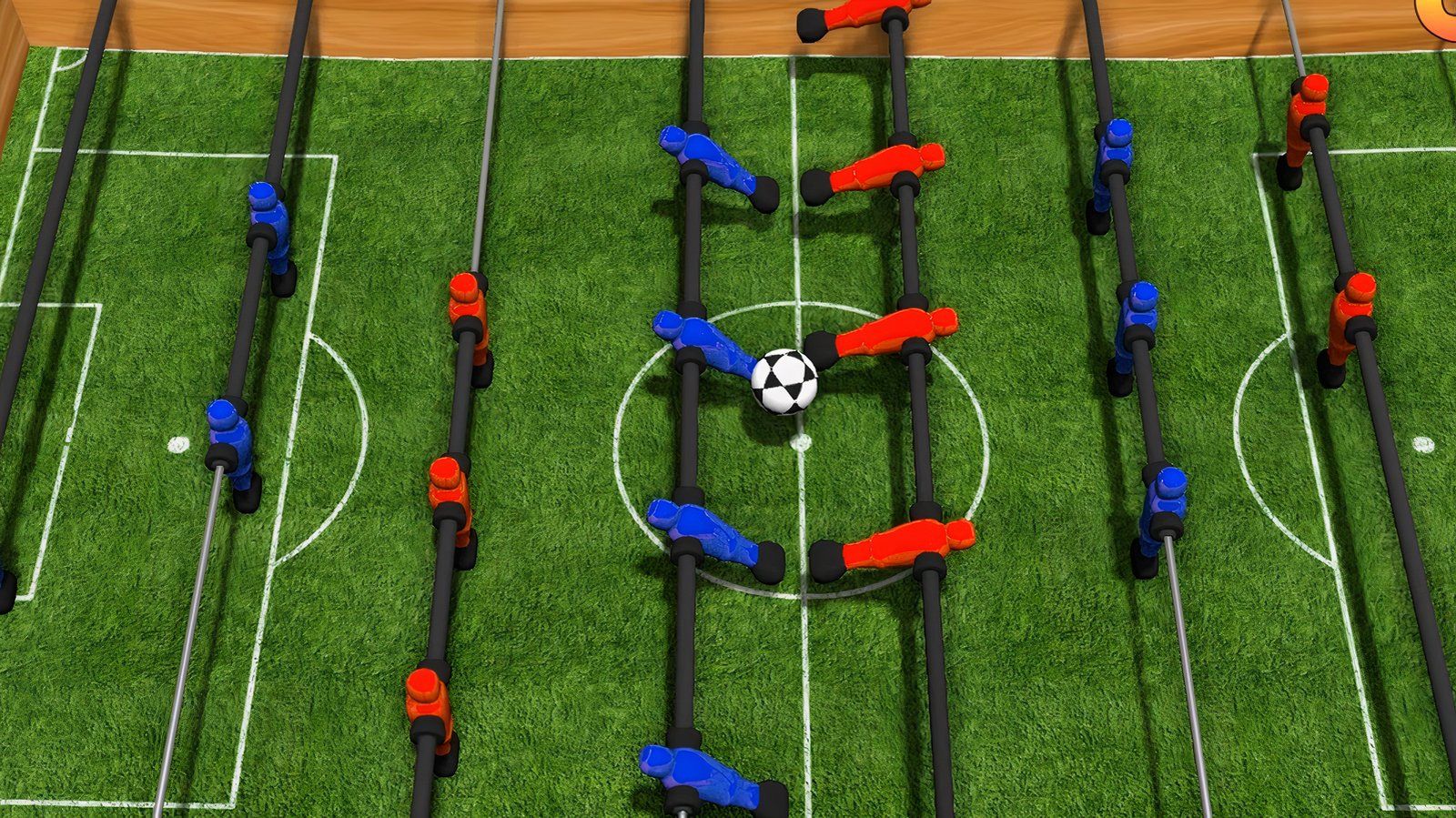 Table football figurines playing with a ball.