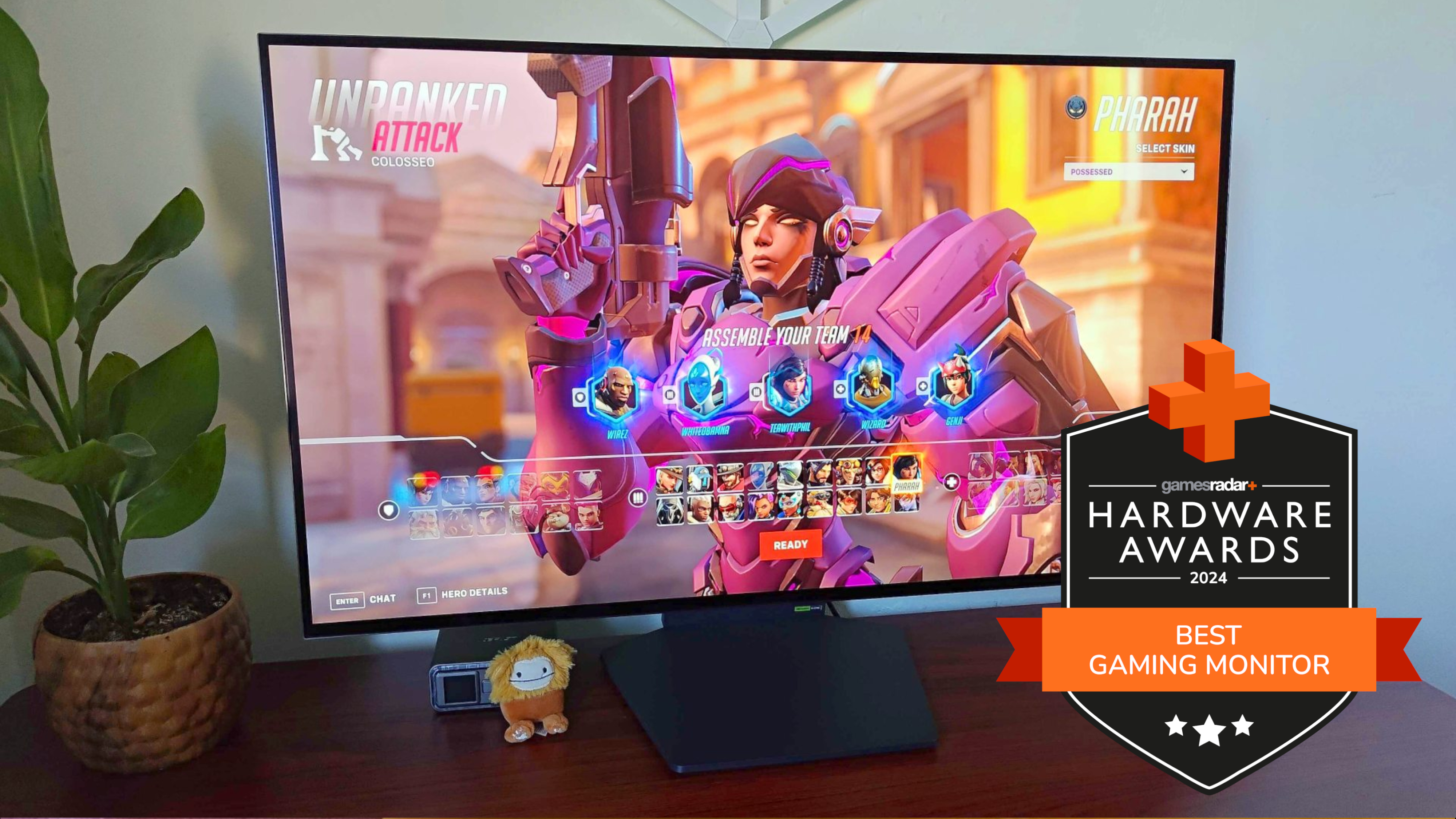 LG UltraGear 32GS95UE-B gaming monitor on a desk running Overwatch 2 with a GamesRadar+ Hardware Awards badge