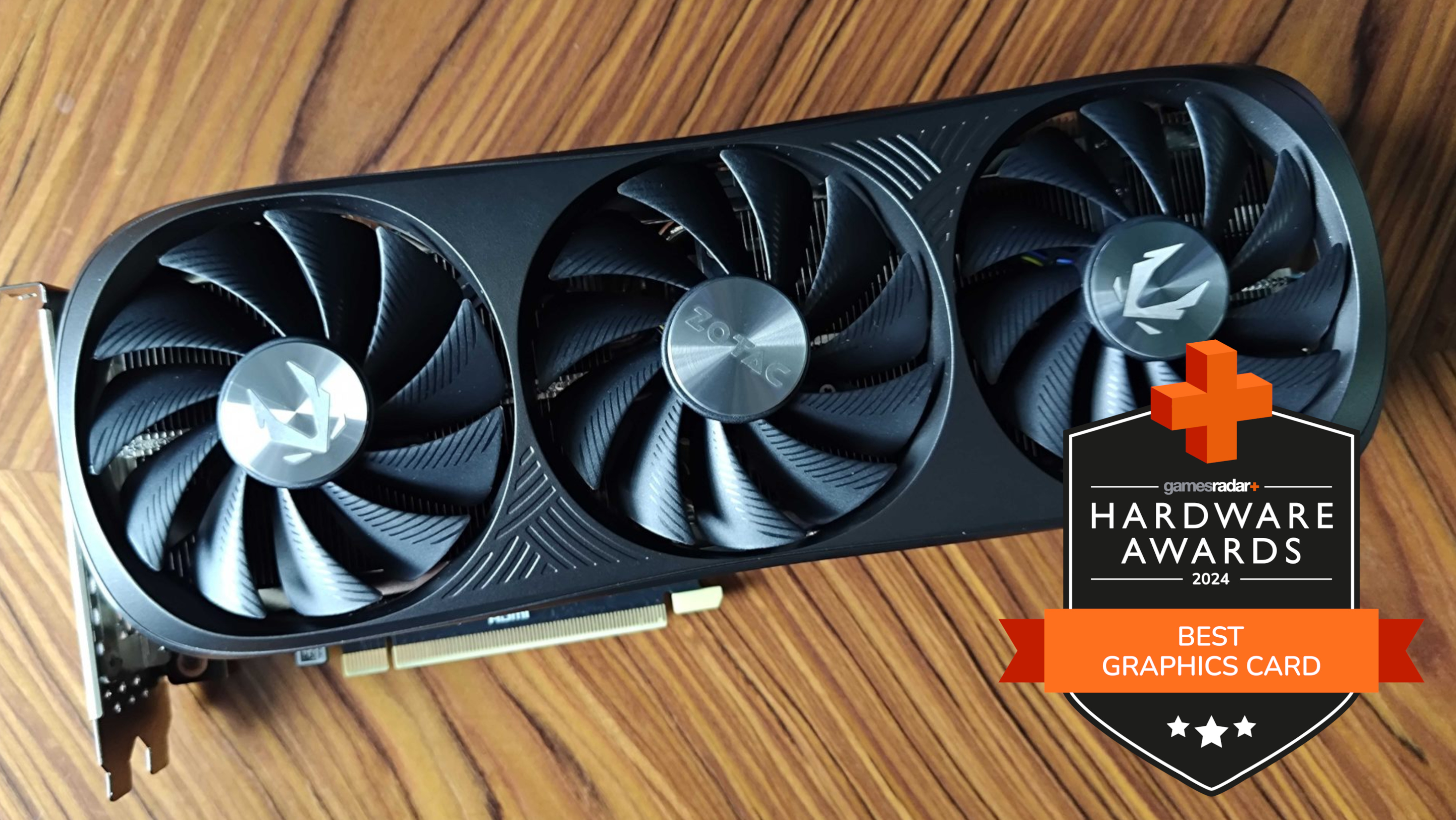 Nvidia GeForce RTX 4070 Super graphics card on a wooden table with GamesRadar+ Hardware Awards badge