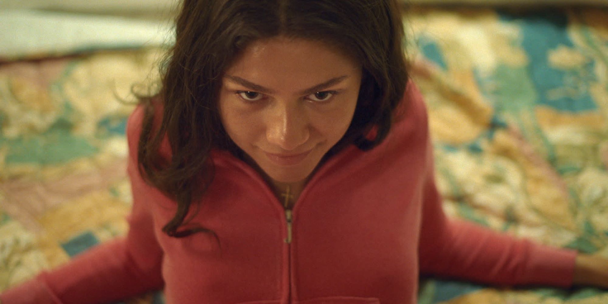 Zendaya smiling in a tracksuit in Challengers